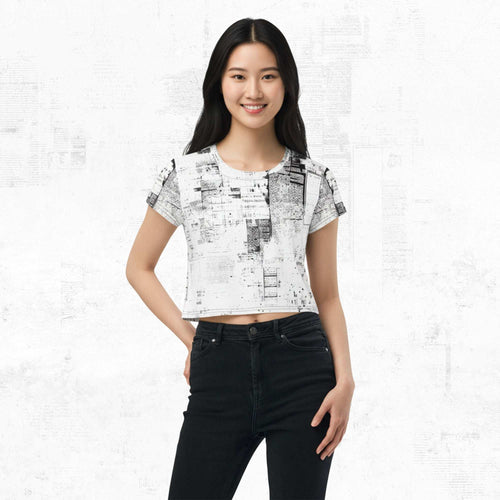 Model wearing Form Finding Design Women’s Era Print (No.04) cropped tee — black-and-white newsprint collage pattern across torso and sleeves, crew neck, styled with black jeans.