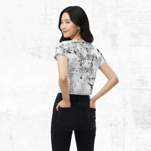 Three-quarter side/back view of model in Form Finding Design Women’s Era Print (No.08) crop tee — distressed monochrome newsprint collage print, cropped hem, fitted sleeves, paired with black jeans.