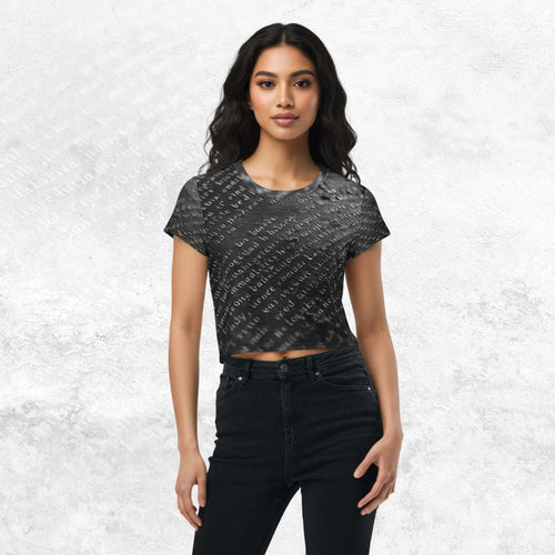 Model wearing Form Finding Design Women’s Era Print (No.15) cropped tee — black-and-white newsprint collage pattern across torso and sleeves, crew neck, styled with black jeans.
