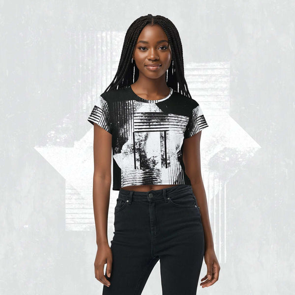 Model wearing Form Finding Design Women’s Era Stamp (No.07) crop tee; bold monochrome distressed geometry print on the front, styled with black jeans against a soft black textured backdrop.