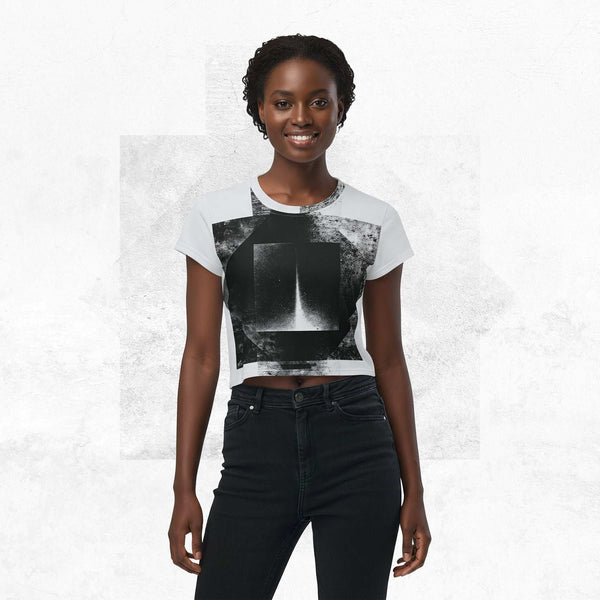 Model wearing Form Finding Design Women’s Era Stamp (No.12) crop tee; bold monochrome distressed geometry print on the front, styled with black jeans against a soft white textured backdrop.