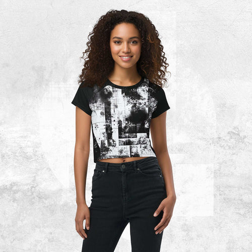 Model wearing Form Finding Design Women’s Era Stamp (No.19) crop tee; bold monochrome distressed geometry print on the front, styled with black jeans against a soft black textured backdrop.