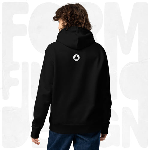 Back view on model: black Women’s Signature Hoodie (FFD-06) by Form Finding Design—minimal back with small white triangle emblem below hood, clean studio background.