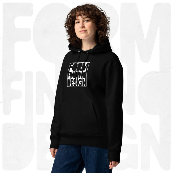 Model wearing black Form Finding Design Women’s Signature Hoodie (FFD-06), three-quarter front—bold white square logo print centred on chest, relaxed fit, soft grey studio backdrop.