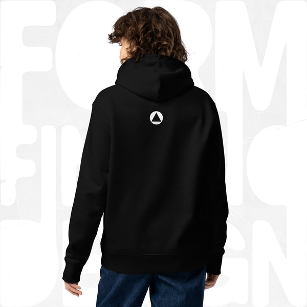 Back view on model: black Women’s Signature Hoodie (FFD-08) by Form Finding Design—minimal back with small white triangle emblem below hood, clean studio background.