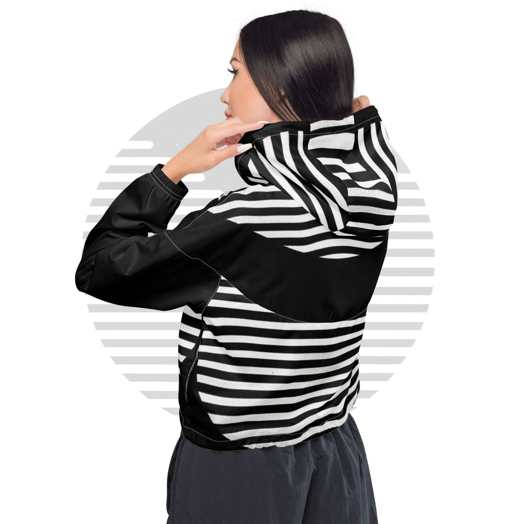 Model wearing white colourway ICN Cropped Windbreaker—three-quarter back pose highlighting hood and wraparound striped graphic, cropped hem with adjustable drawcord from Form Finding Design.