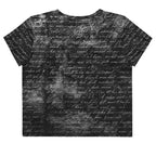 Flat studio mockup of Form Finding Design “Women’s Era Print (No.19)” crop tee, back — monochrome handwritten script collage across body and sleeves; crew neck, cropped hem; The Signature Collective.