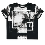 Back view of Women's Era Stamp (No.03) crop top with bold black and white geometries, distressed ink texture, crew neck, short sleeves.