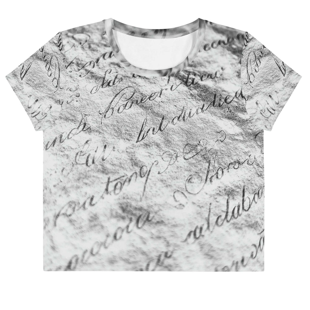 Flat studio mockup of Form Finding Design “Women’s Era Print (No.12)” crop tee, front — monochrome handwritten script collage across body and sleeves; crew neck, cropped hem; The Signature Collective.