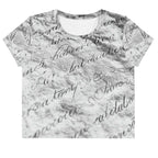 Flat studio mockup of Form Finding Design “Women’s Era Print (No.12)” crop tee, front — monochrome handwritten script collage across body and sleeves; crew neck, cropped hem; The Signature Collective.