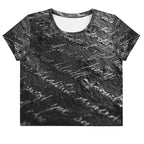 Flat studio mockup of Form Finding Design “Women’s Era Print (No.13)” crop tee, front — monochrome handwritten script collage across body and sleeves; crew neck, cropped hem; The Signature Collective.