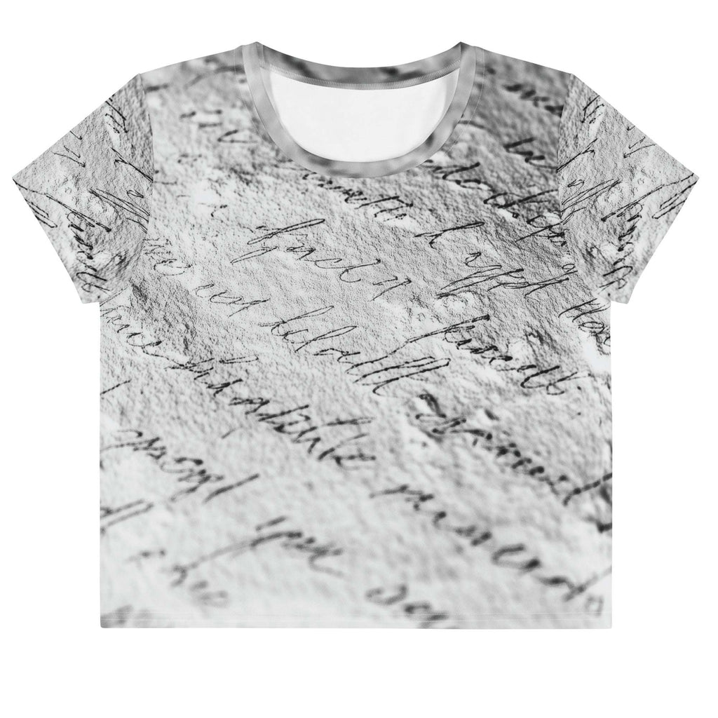 Flat studio mockup of Form Finding Design “Women’s Era Print (No.14)” crop tee, front — monochrome handwritten script collage across body and sleeves; crew neck, cropped hem; The Signature Collective.