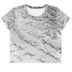 Flat studio mockup of Form Finding Design “Women’s Era Print (No.14)” crop tee, front — monochrome handwritten script collage across body and sleeves; crew neck, cropped hem; The Signature Collective.