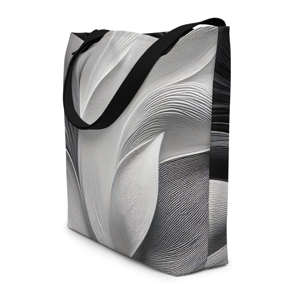Three-quarter angle of Silver Bloom Tote Bag highlighting sculpted curves of the greyscale abstract line artwork wrapping around the sides, spacious polyester body and long black handles – modern monochrome designer tote for beach days, city commutes and travel by Form Finding Design.