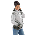 “Women’s Watercolour-Print-14 Muse Hoodie side model in white with gray hand-painted landscape design, featuring abstract mountains and trees, kangaroo pocket, and adjustable drawstring hood.”