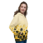 An FFD Luminescence-4 hoodie (side model pose) with a black, white and yellow gradient print of a nature-inspired design featuring hues of white yellow and black tones.