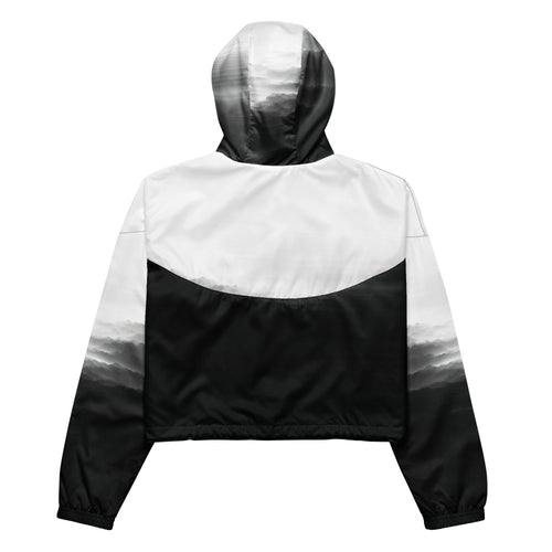 Back studio view of the HER Cropped Dither Distortion Windbreaker (No.03), showing the hood and cropped silhouette. The digital distortion print runs from light grey at the upper back to deep charcoal at the hem; the hood’s outer panels are colour‑blocked in black and white, and the elasticated hem is cinched with a drawcord, all set against a clean white backdrop