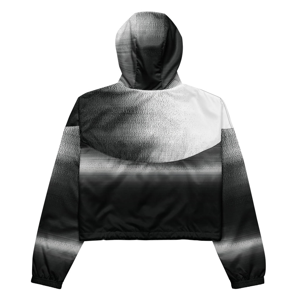 Back studio view of the HER Cropped Dither Distortion Windbreaker, showing the hood and cropped silhouette. The digital distortion print runs from light grey at the upper back to deep charcoal at the hem; the hood’s outer panels are colour‑blocked in black and white, and the elasticated hem is cinched with a drawcord, all set against a clean white backdrop