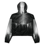 Back studio view of the HER Cropped Dither Distortion Windbreaker (No.02), showing the hood and cropped silhouette. The digital distortion print runs from light grey at the upper back to deep charcoal at the hem; the hood’s outer panels are colour‑blocked in black and white, and the elasticated hem is cinched with a drawcord, all set against a clean white backdrop