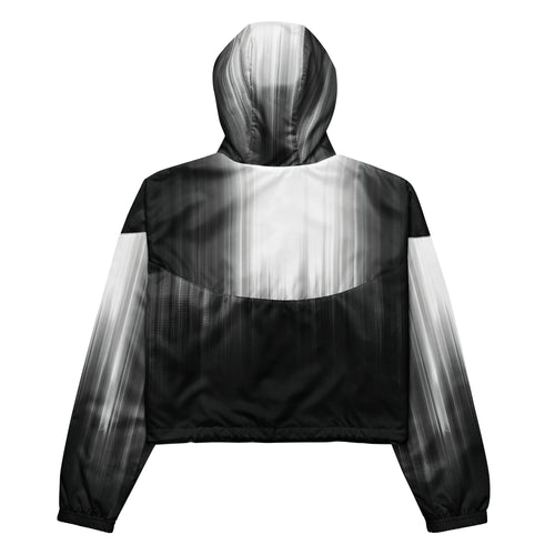 Back studio view of the HER Cropped Dither Distortion Windbreaker (No.04), showing the hood and cropped silhouette. The digital distortion print runs from light grey at the upper back to deep charcoal at the hem; the hood’s outer panels are colour‑blocked in black and white, and the elasticated hem is cinched with a drawcord, all set against a clean white backdrop