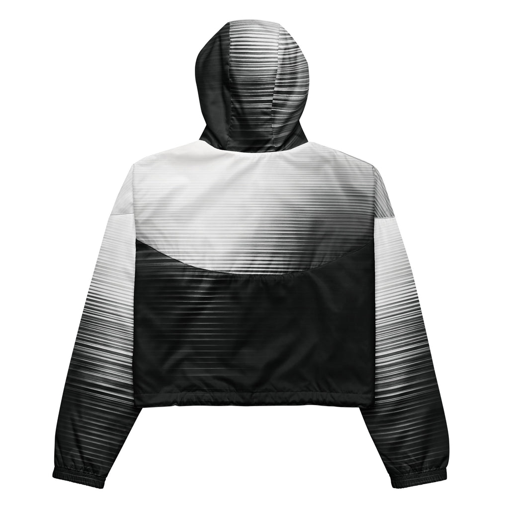 Back studio view of the HER Cropped Dither Distortion Windbreaker (No.05), showing the hood and cropped silhouette. The digital distortion print runs from light grey at the upper back to deep charcoal at the hem; the hood’s outer panels are colour‑blocked in black and white, and the elasticated hem is cinched with a drawcord, all set against a clean white backdrop