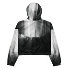 Back studio view of the HER Cropped Dither Distortion Windbreaker (No.06), showing the hood and cropped silhouette. The digital distortion print runs from light grey at the upper back to deep charcoal at the hem; the hood’s outer panels are colour‑blocked in black and white, and the elasticated hem is cinched with a drawcord, all set against a clean white backdrop
