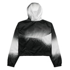Back studio view of the HER Cropped Dither Distortion Windbreaker (No.07), showing the hood and cropped silhouette. The digital distortion print runs from light grey at the upper back to deep charcoal at the hem; the hood’s outer panels are colour‑blocked in black and white, and the elasticated hem is cinched with a drawcord, all set against a clean white backdrop