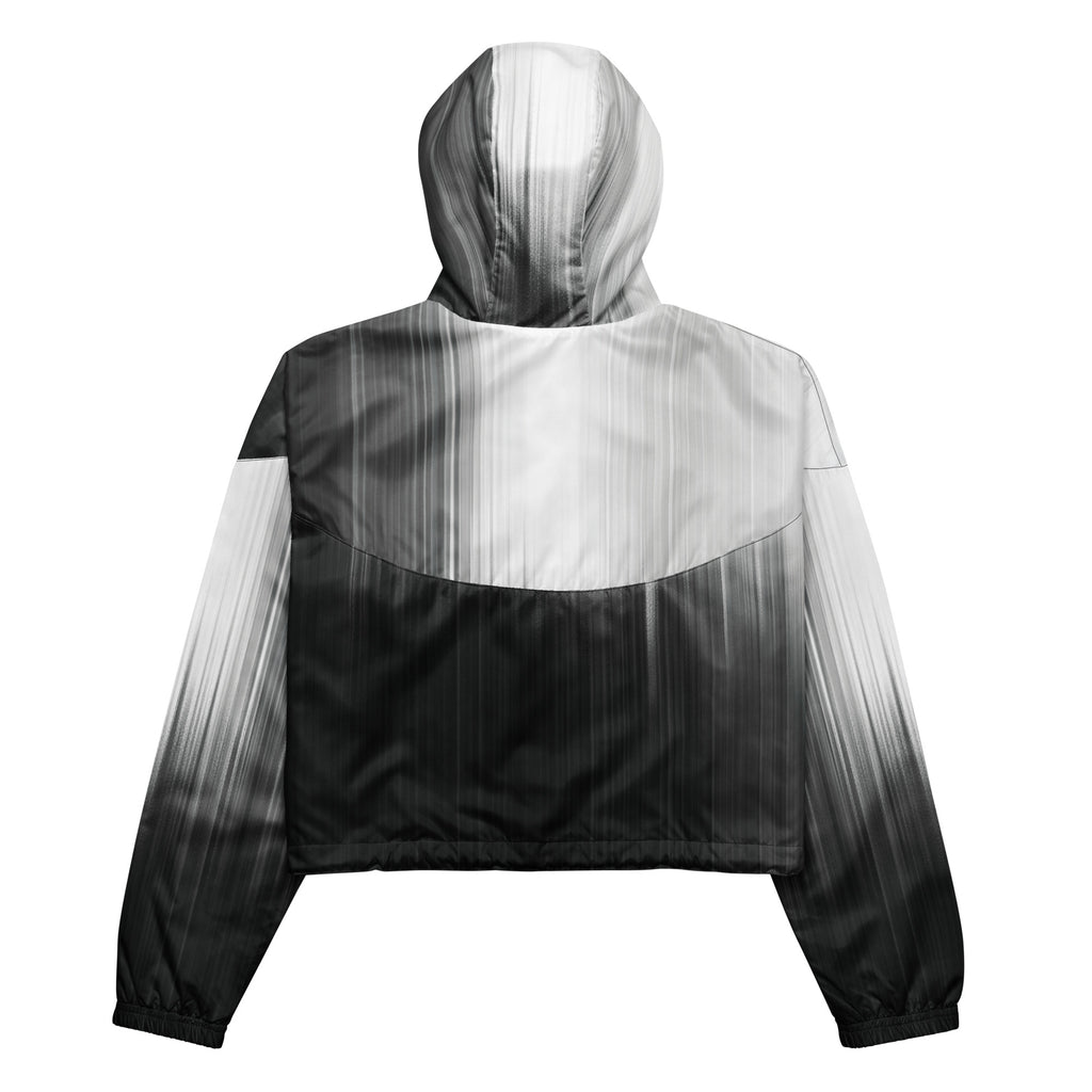 Back studio view of the HER Cropped Dither Distortion Windbreaker (No.08), showing the hood and cropped silhouette. The digital distortion print runs from light grey at the upper back to deep charcoal at the hem; the hood’s outer panels are colour‑blocked in black and white, and the elasticated hem is cinched with a drawcord, all set against a clean white backdrop