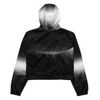 Back studio view of the HER Cropped Dither Distortion Windbreaker (No.09), showing the hood and cropped silhouette. The digital distortion print runs from light grey at the upper back to deep charcoal at the hem; the hood’s outer panels are colour‑blocked in black and white, and the elasticated hem is cinched with a drawcord, all set against a clean white backdrop
