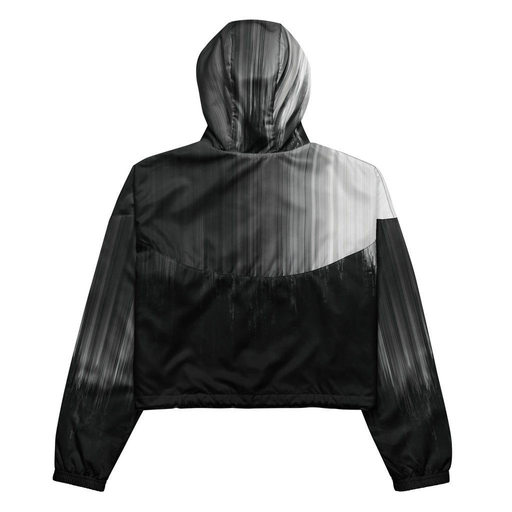 Back studio view of the HER Cropped Dither Distortion Windbreaker (No.10), showing the hood and cropped silhouette. The digital distortion print runs from light grey at the upper back to deep charcoal at the hem; the hood’s outer panels are colour‑blocked in black and white, and the elasticated hem is cinched with a drawcord, all set against a clean white backdrop