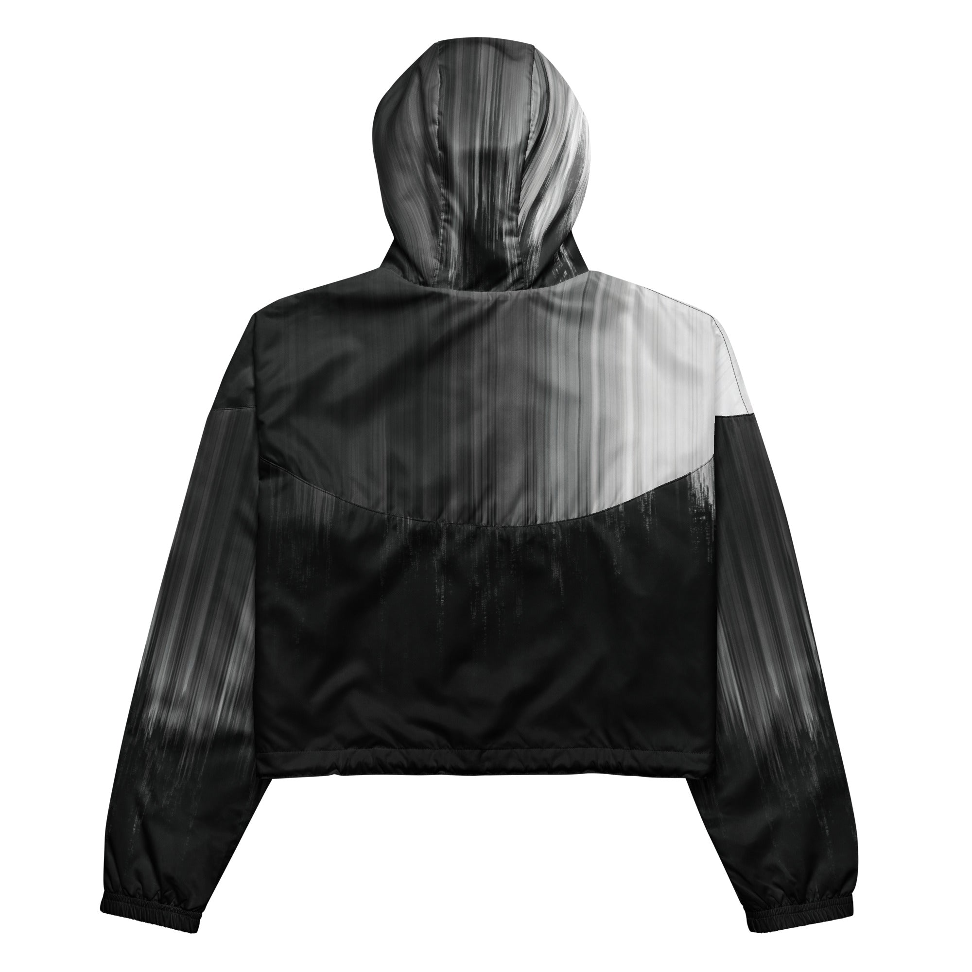 Back studio view of the HER Cropped Dither Distortion Windbreaker (No.10), showing the hood and cropped silhouette. The digital distortion print runs from light grey at the upper back to deep charcoal at the hem; the hood’s outer panels are colour‑blocked in black and white, and the elasticated hem is cinched with a drawcord, all set against a clean white backdrop