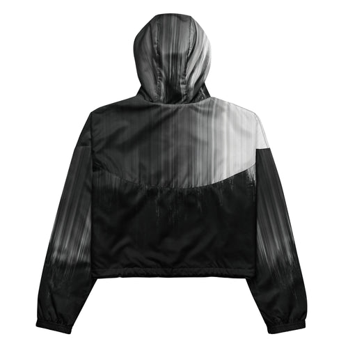 Back studio view of the HER Cropped Dither Distortion Windbreaker (No.10), showing the hood and cropped silhouette. The digital distortion print runs from light grey at the upper back to deep charcoal at the hem; the hood’s outer panels are colour‑blocked in black and white, and the elasticated hem is cinched with a drawcord, all set against a clean white backdrop