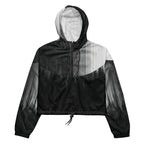 HER Cropped Dither Distortion Windbreaker (No.10) by Form Finding Design, front studio view — cropped hooded jacket with a monochrome graphic distortion print fading from white at the shoulders to dark charcoal at the hem. Features a half‑zip front, black drawstrings, long sleeves and an elasticated hem with a drawcord, displayed on a plain white background