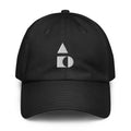 A crisp front view of the black Under Armour x Form Fundamentals Stamp Cap (No.04), showing its six‑panel construction, curved brim and the white geometric Form Fundamentals logo embroidered on the front.