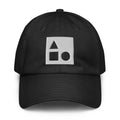 A crisp front view of the black Under Armour x Form Fundamentals Stamp Cap (No.18), showing its six‑panel construction, curved brim and the white geometric Form Fundamentals logo embroidered on the front.