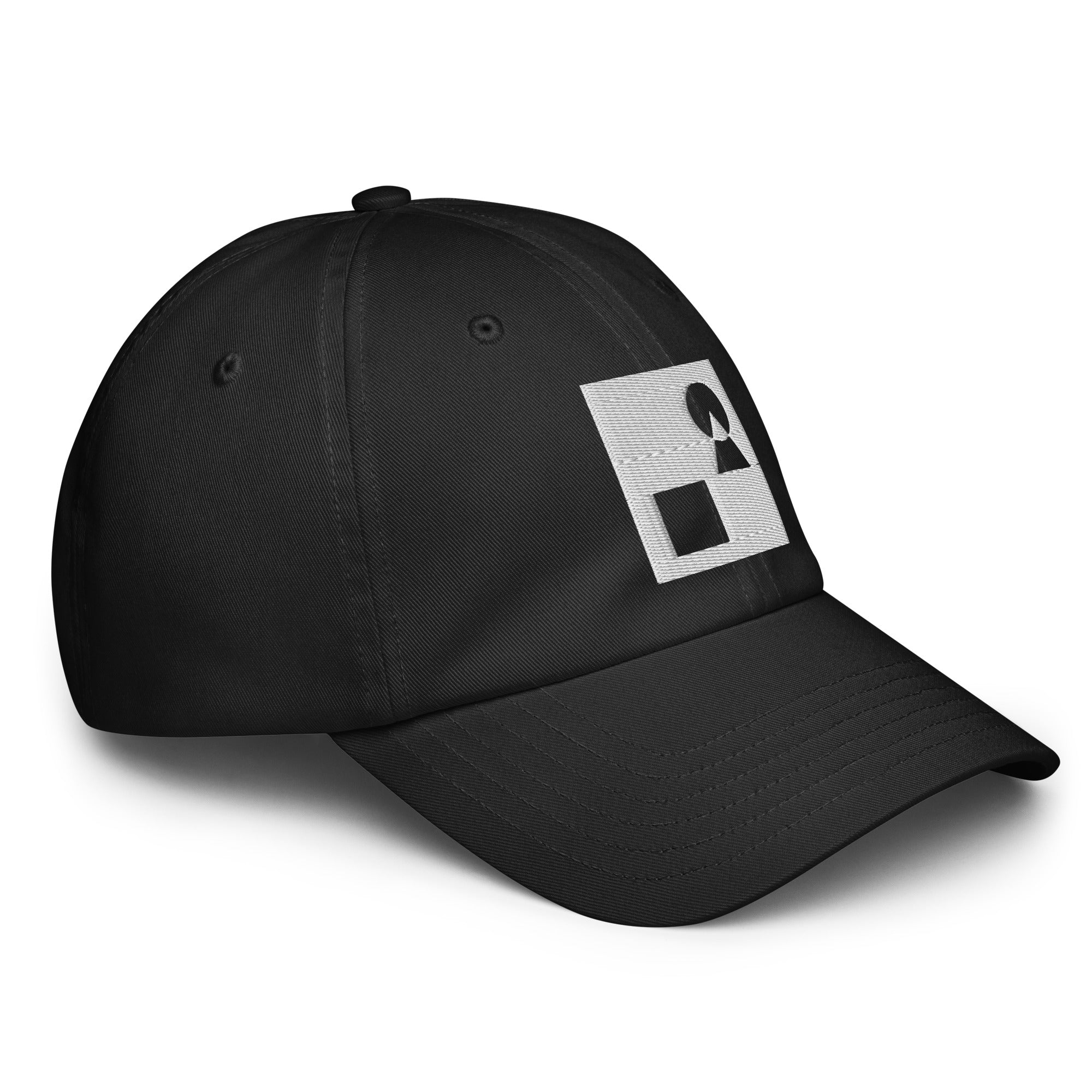 Detailed close‑up of the black Under Armour x Form Fundamentals Stamp Cap (No.16), focusing on the fine fabric texture, stitched seams and partial white Form Fundamentals logo on the side of the structured crown.