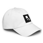 Detailed close‑up of the white Under Armour x Form Fundamentals Stamp Cap (No.11), focusing on the fine fabric texture, stitched seams and partial black Form Fundamentals logo on the side of the structured crown.